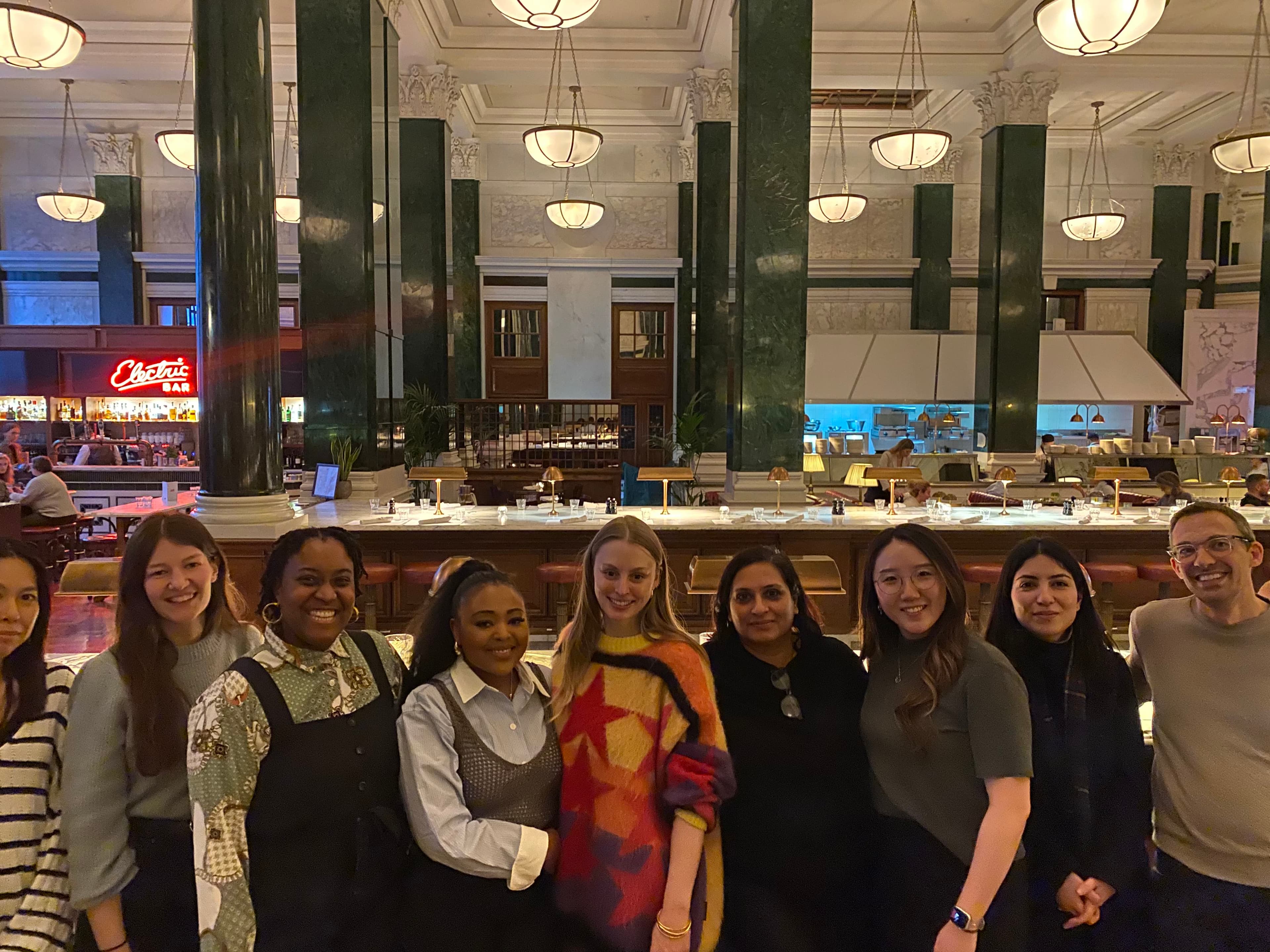 Headstrong team members smiling together at a team dinner